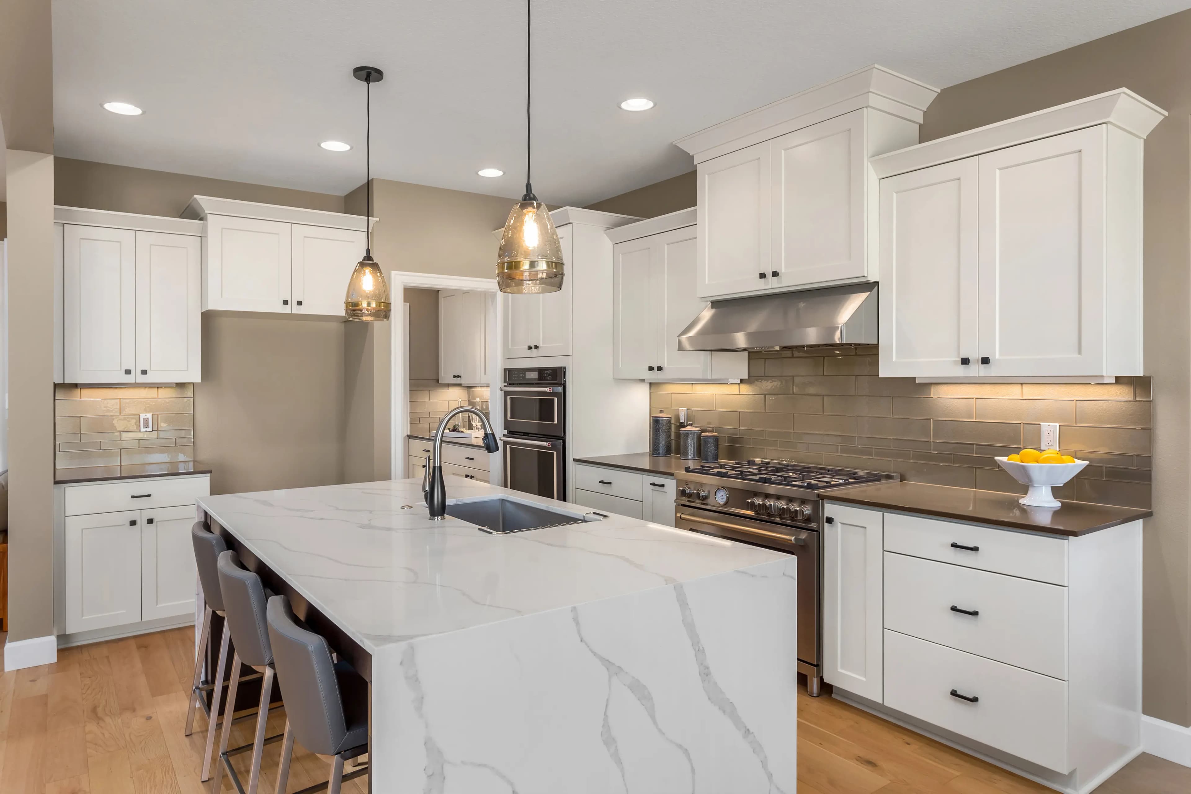 Modern kitchen with custom cabinetry and elegant lighting in a remodeled Dallas home.